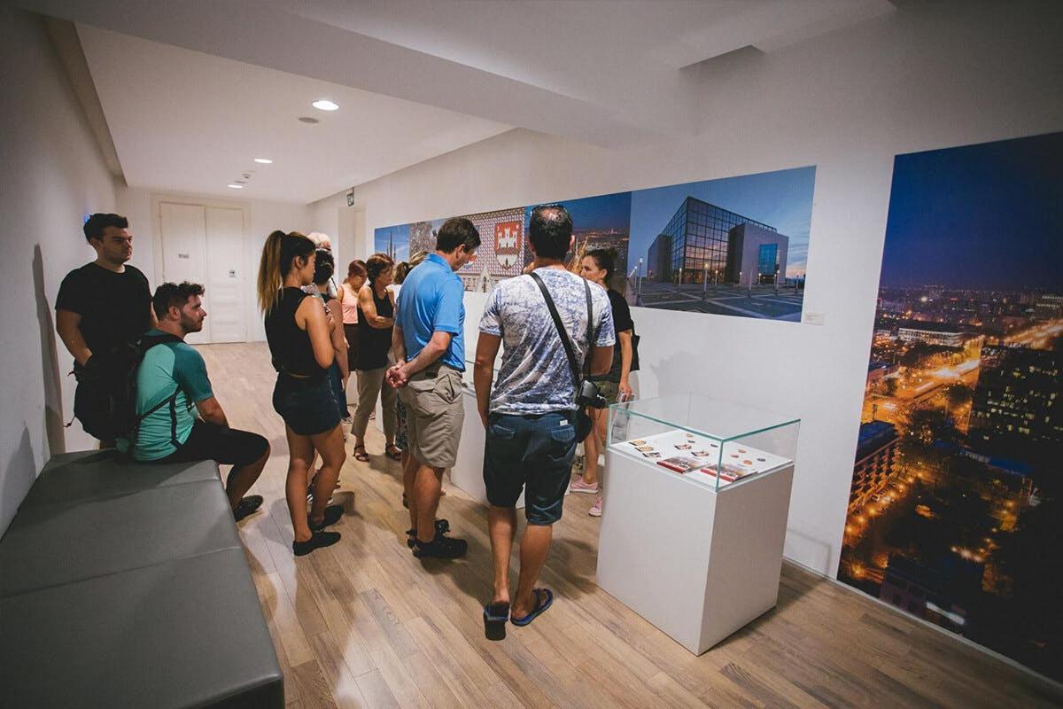 a group of people standing in a room looking at art