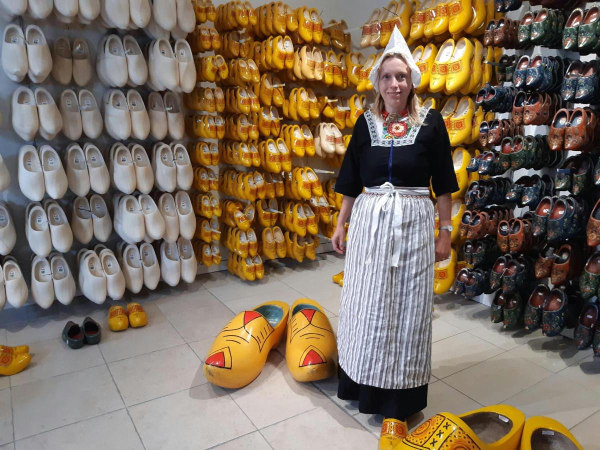 a woman standing in front of a store with shoes