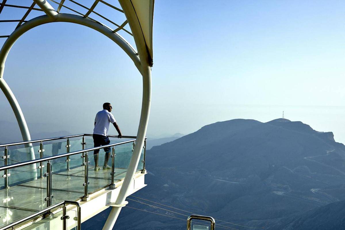 a man standing on the edge of a viewing deck