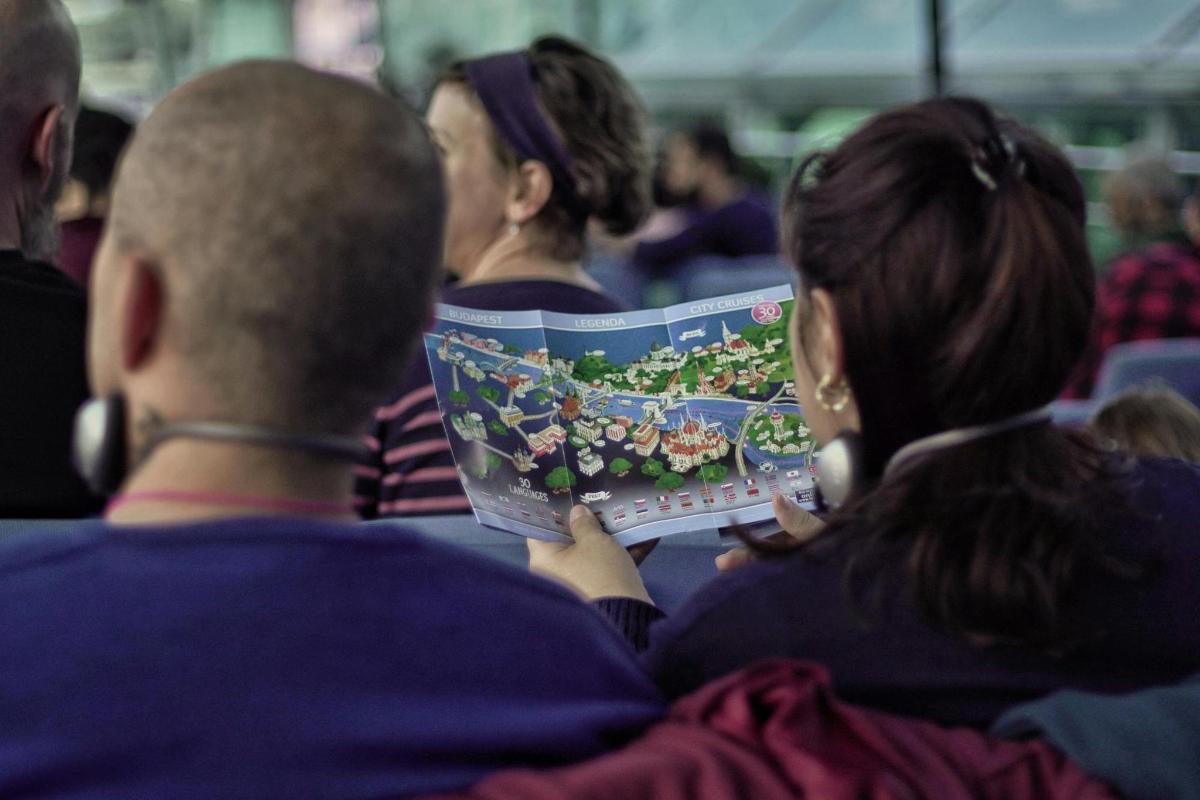 a group of people sitting down reading a magazine