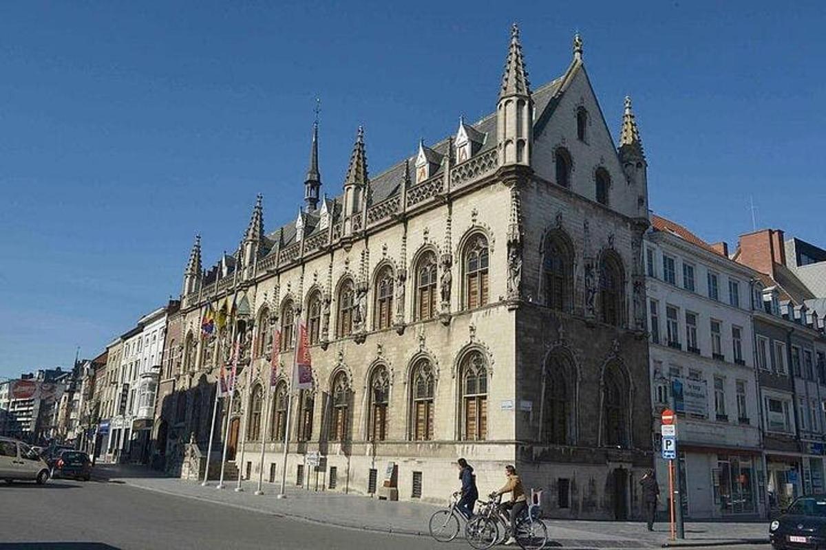 a large building with people riding bikes in front of it