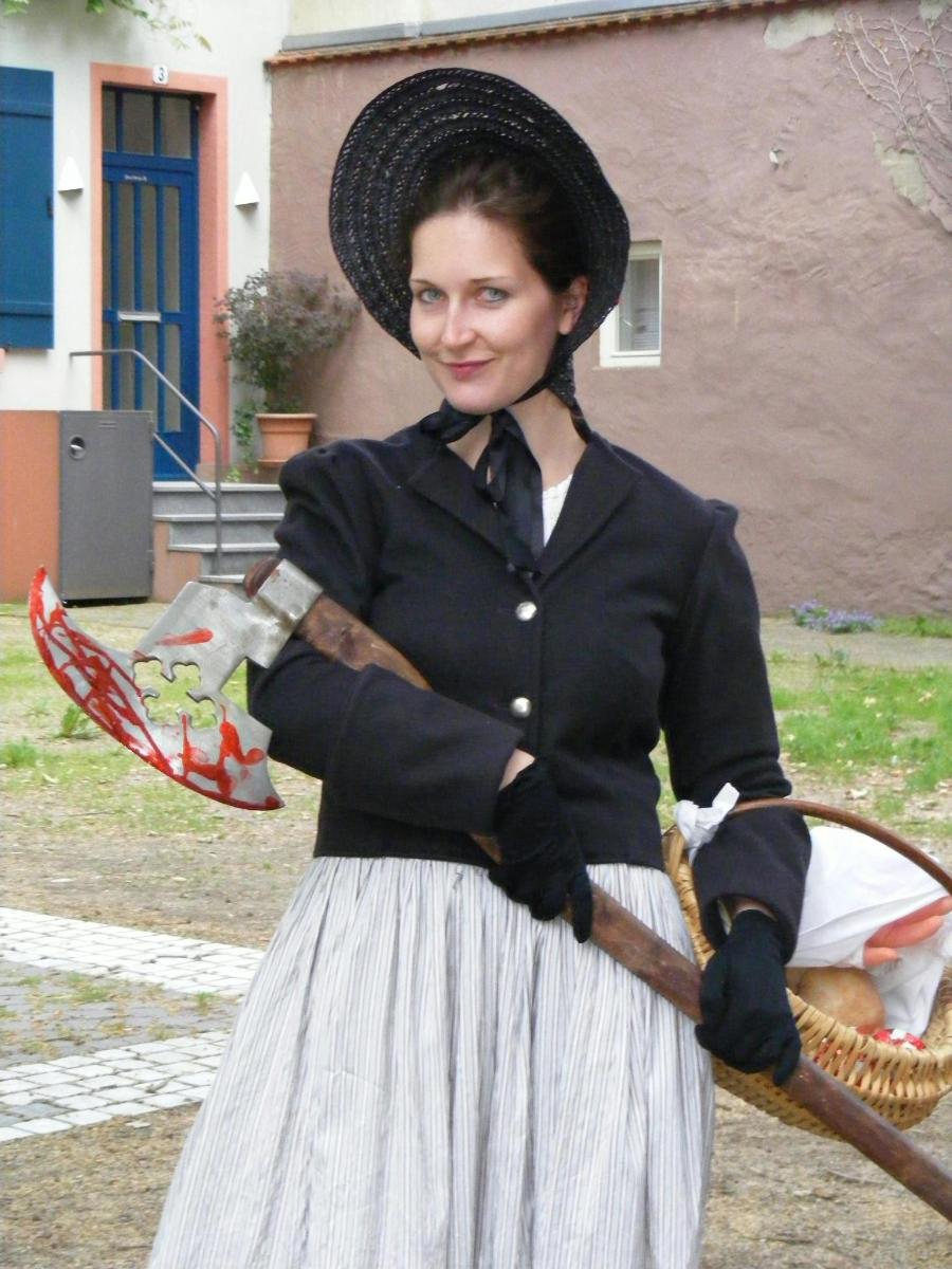 a woman in a hat holding a tennis racket