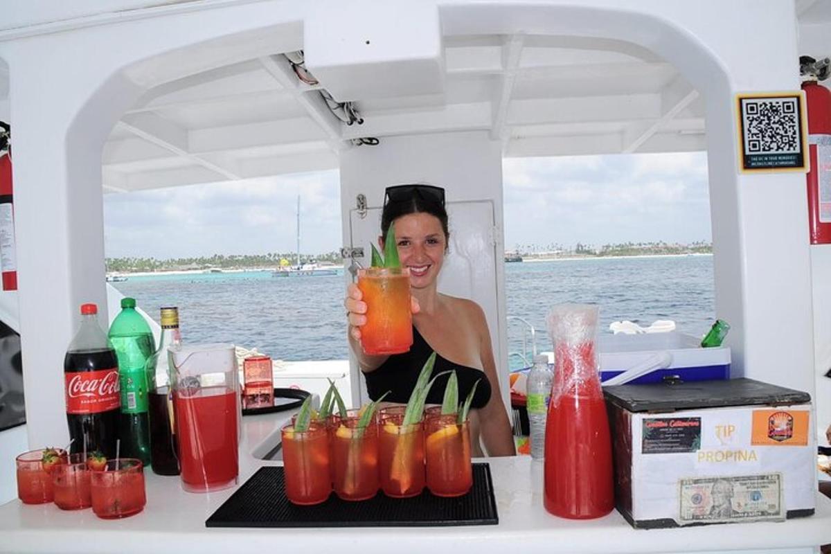a woman standing behind a counter with a bunch of drinks
