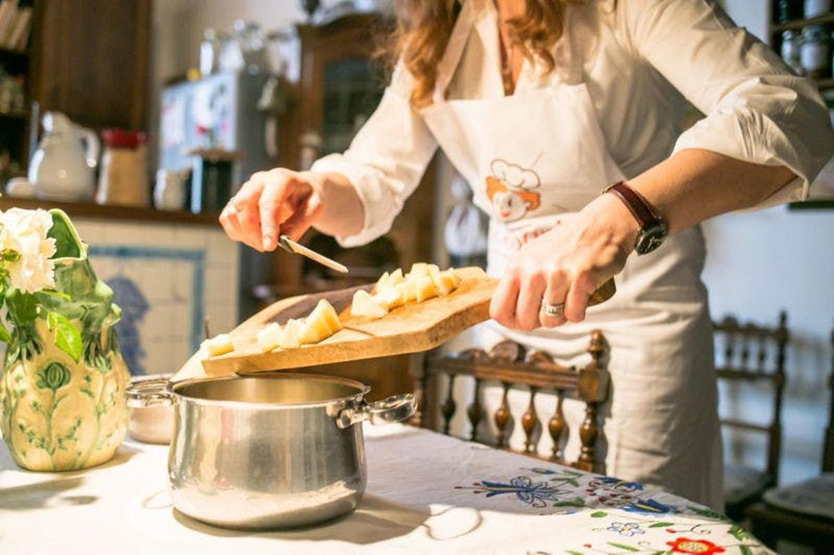 a woman in a kitchen preparing food on a table