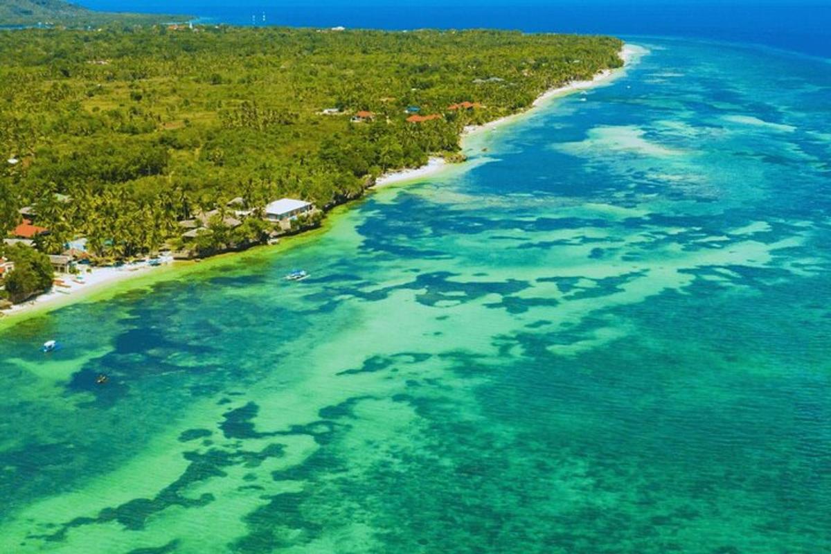 an aerial view of a beach with turquoise water