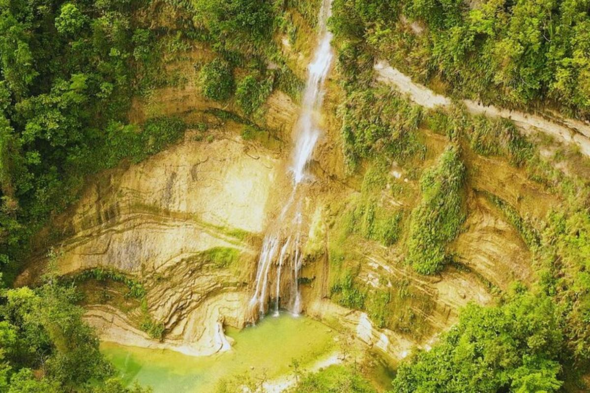 an aerial view of a waterfall on the side of a mountain