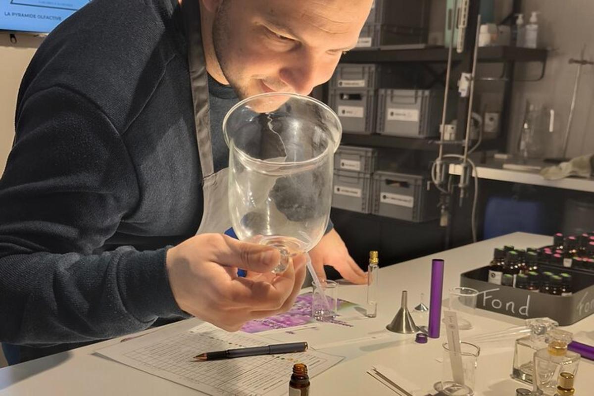 a man is holding a glass on a desk