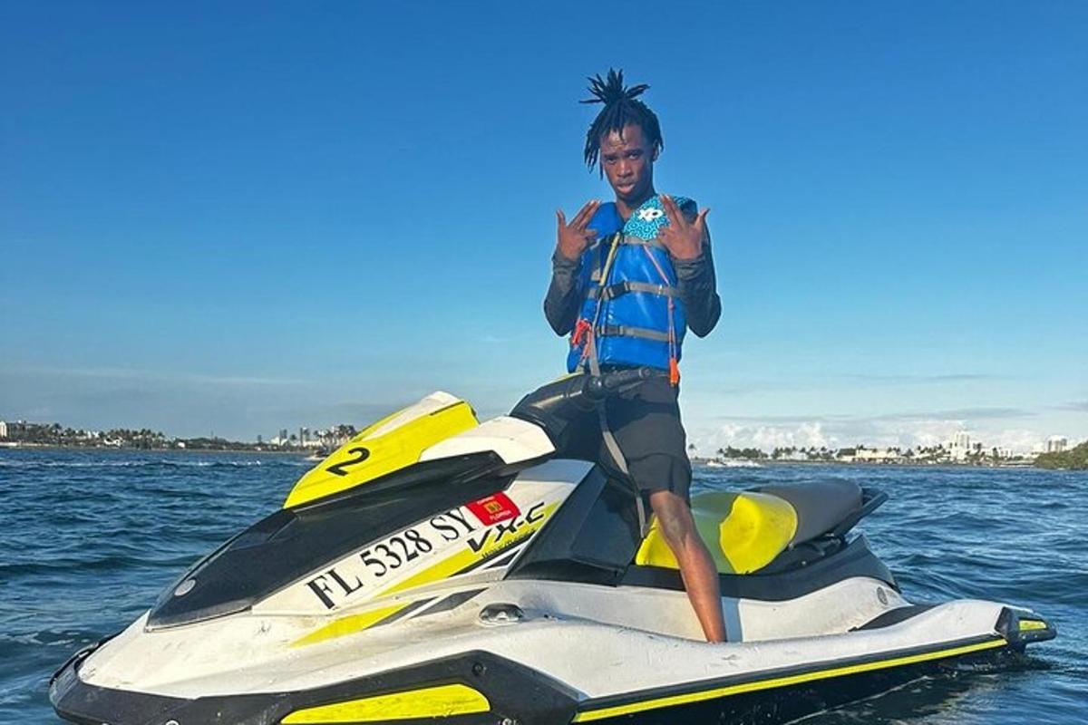 a man standing on a jet ski in the water
