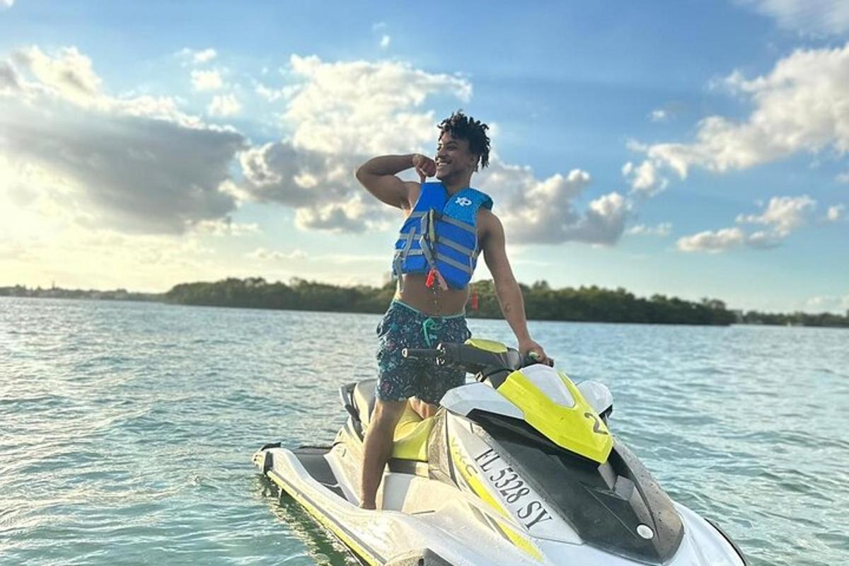 a man in a life vest on a jet ski on the water