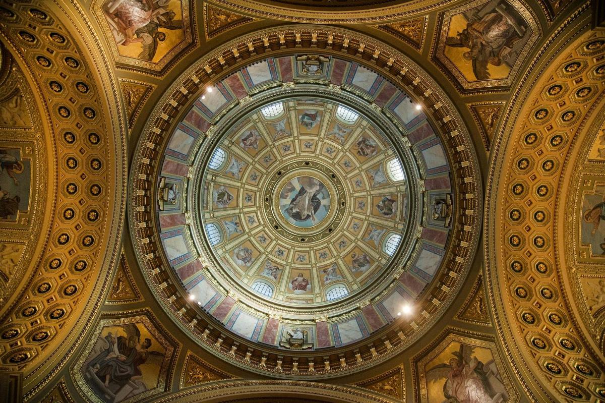 a ceiling of a building with a painting on it