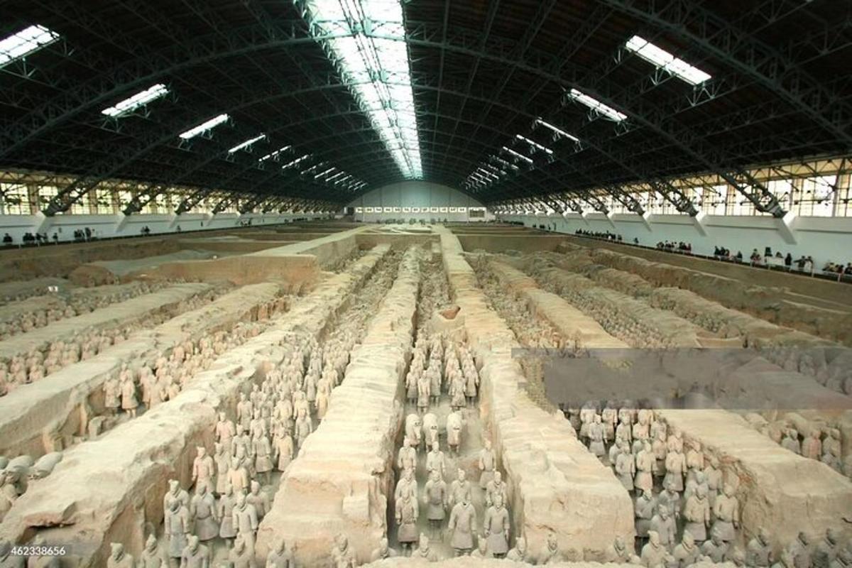 a large room filled with lots of people in a building