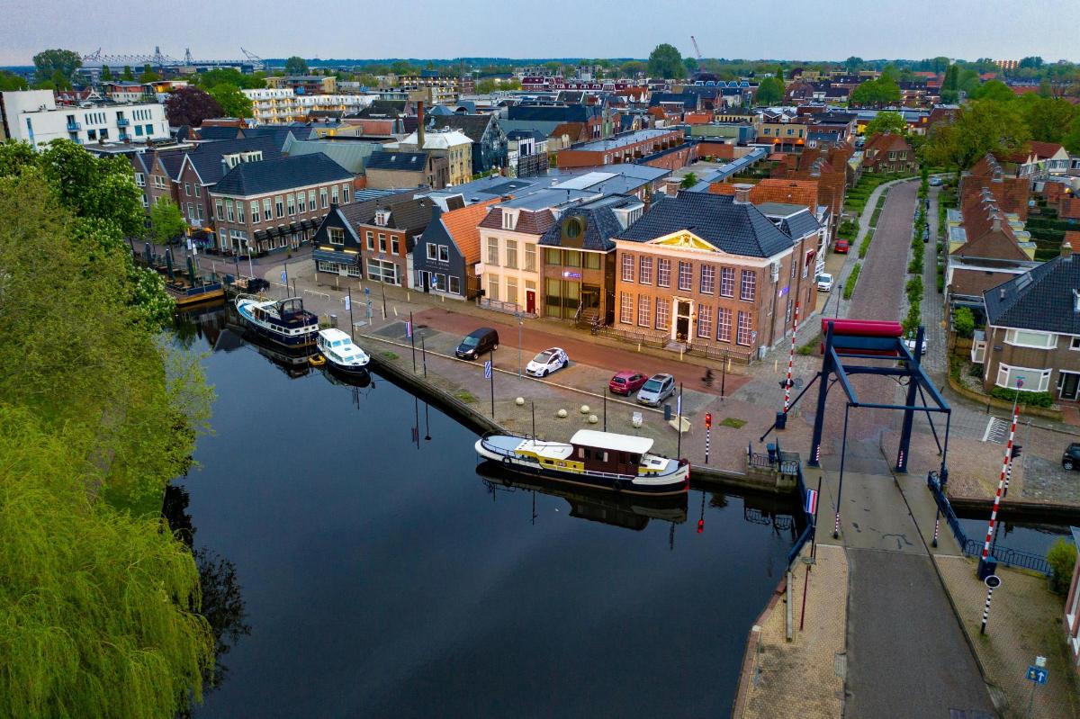 an aerial view of a city with boats in the water