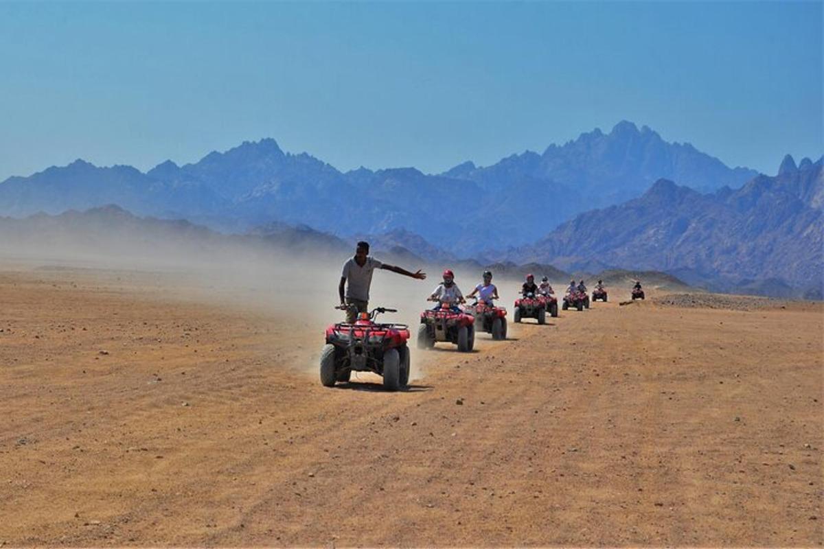 a group of people riding atvs in the desert