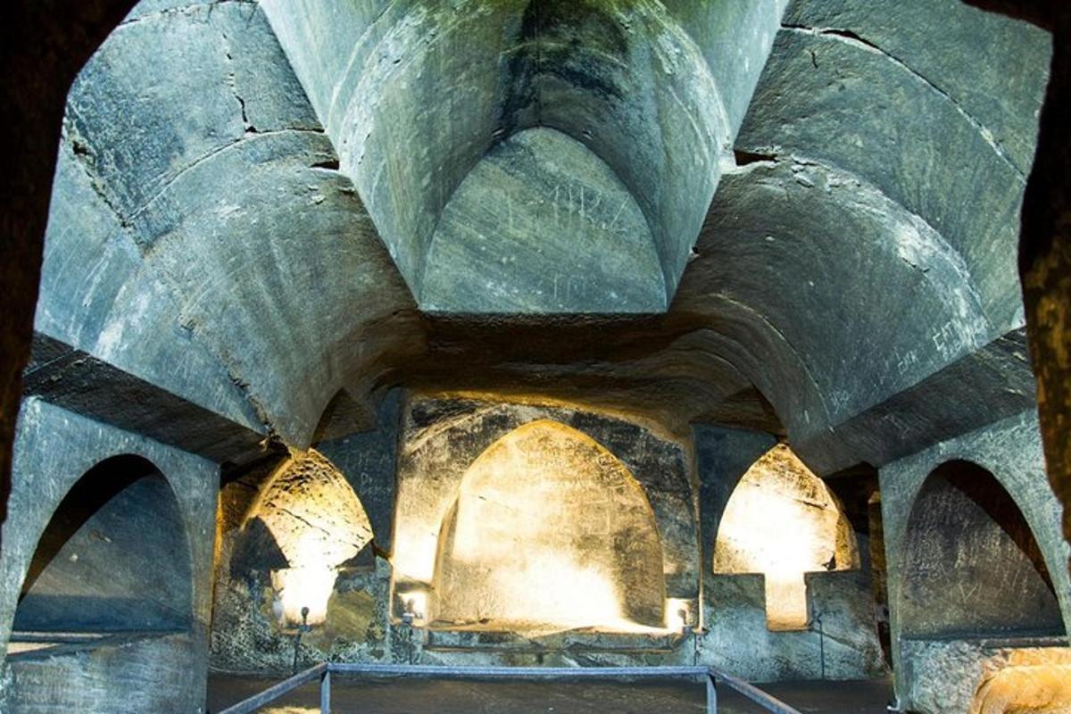 a stone building with arches and lights on it