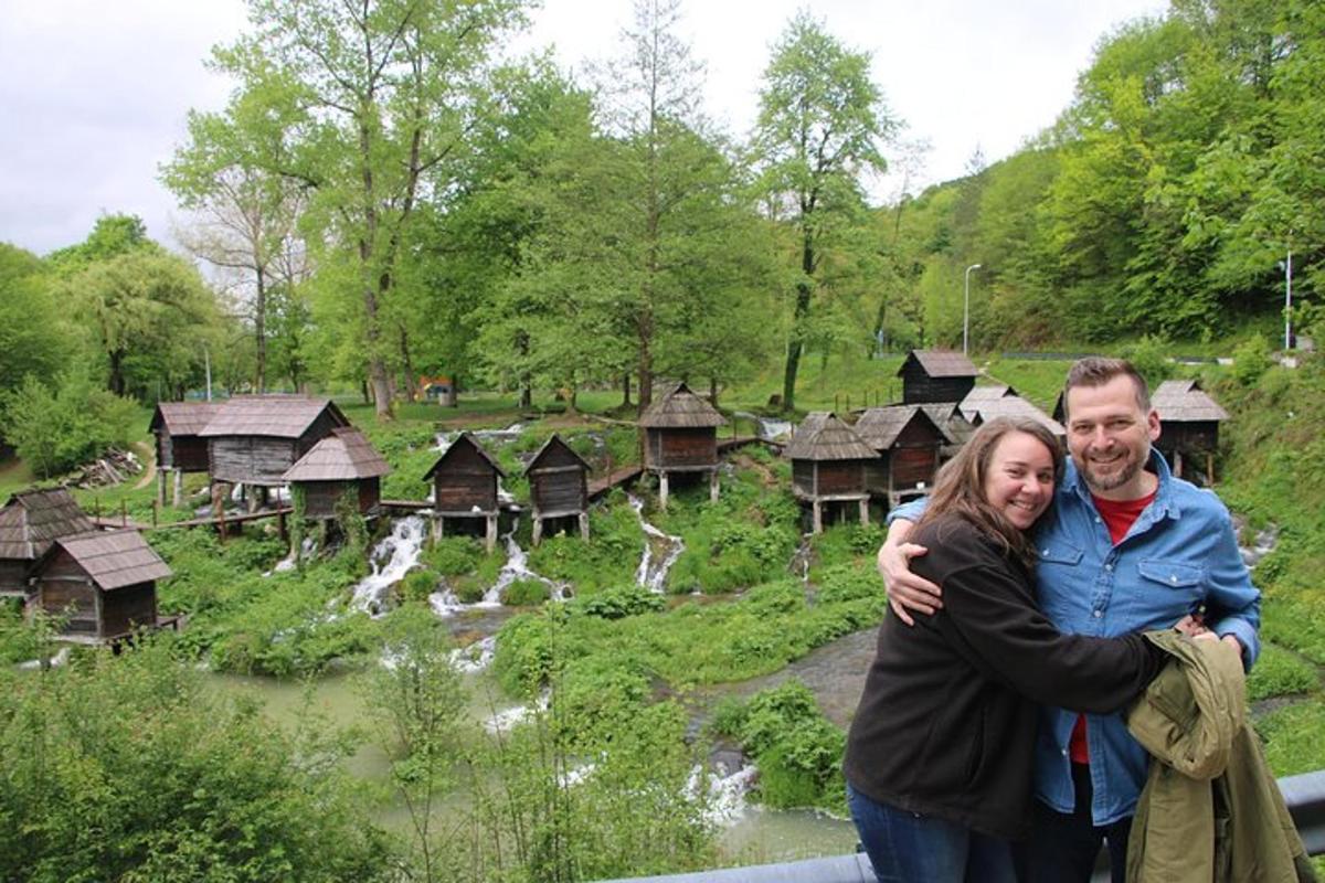a man and a woman standing in front of a village
