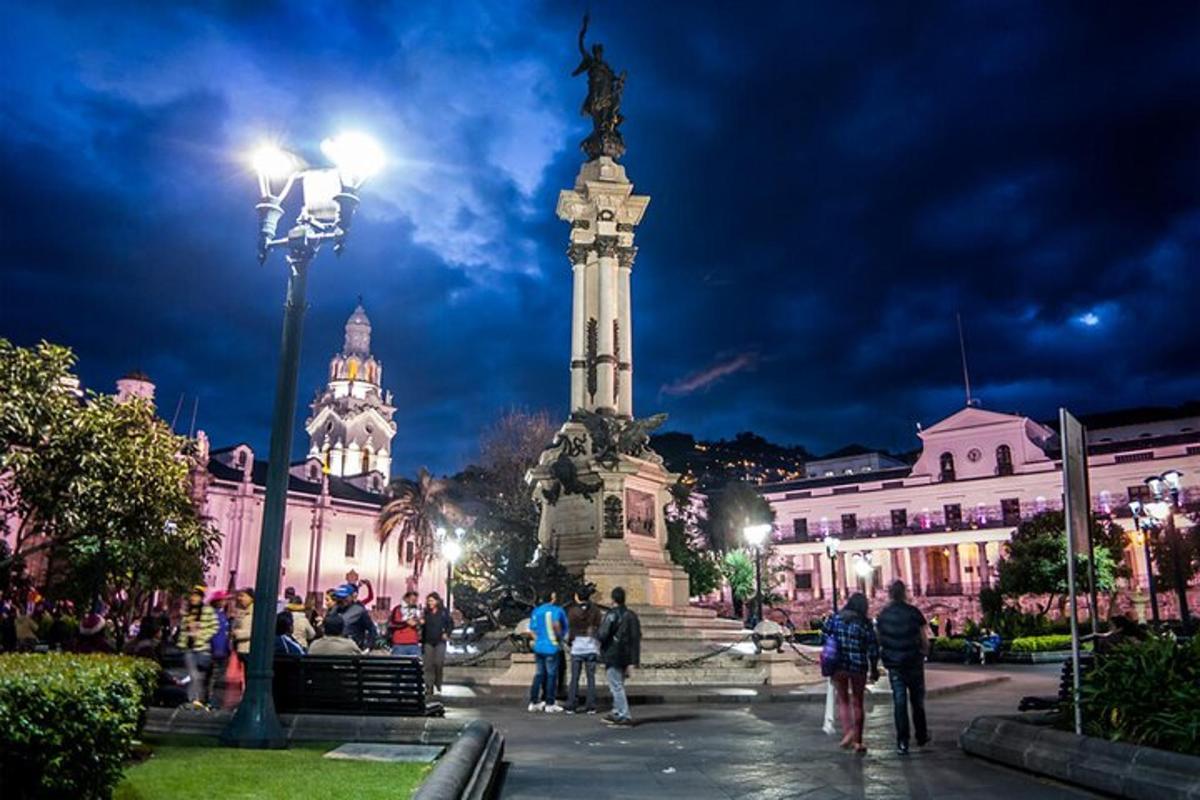 a group of people standing around a statue in a city