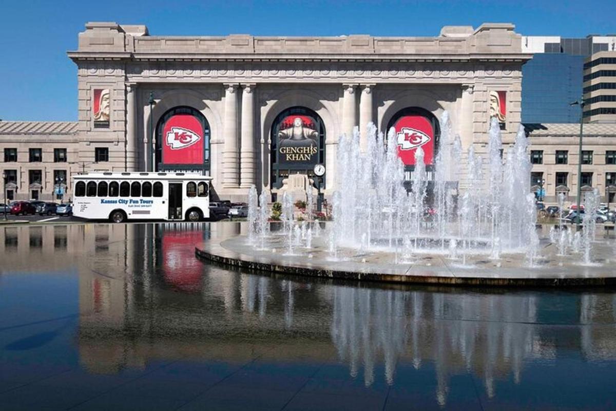 a bus parked in front of a fountain in front of a building