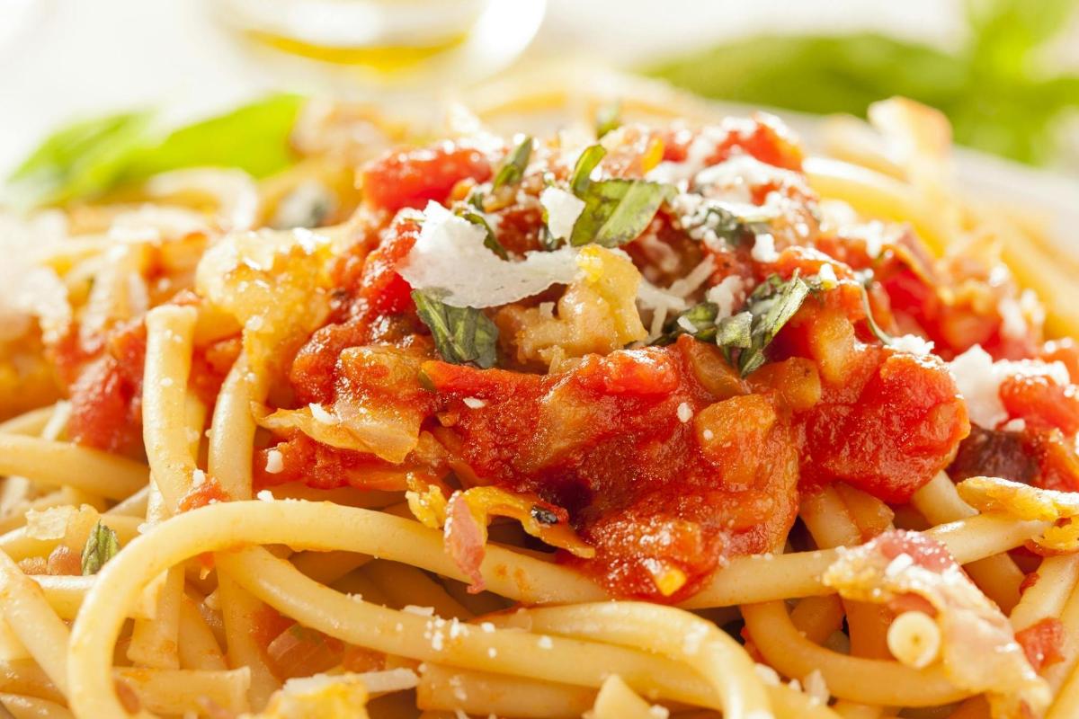 a plate of pasta with tomato sauce and cheese
