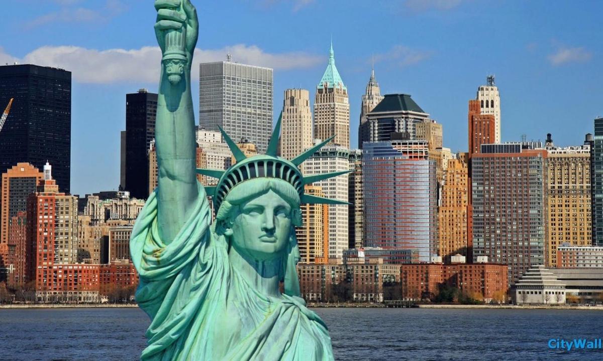 a statue of liberty with a city in the background