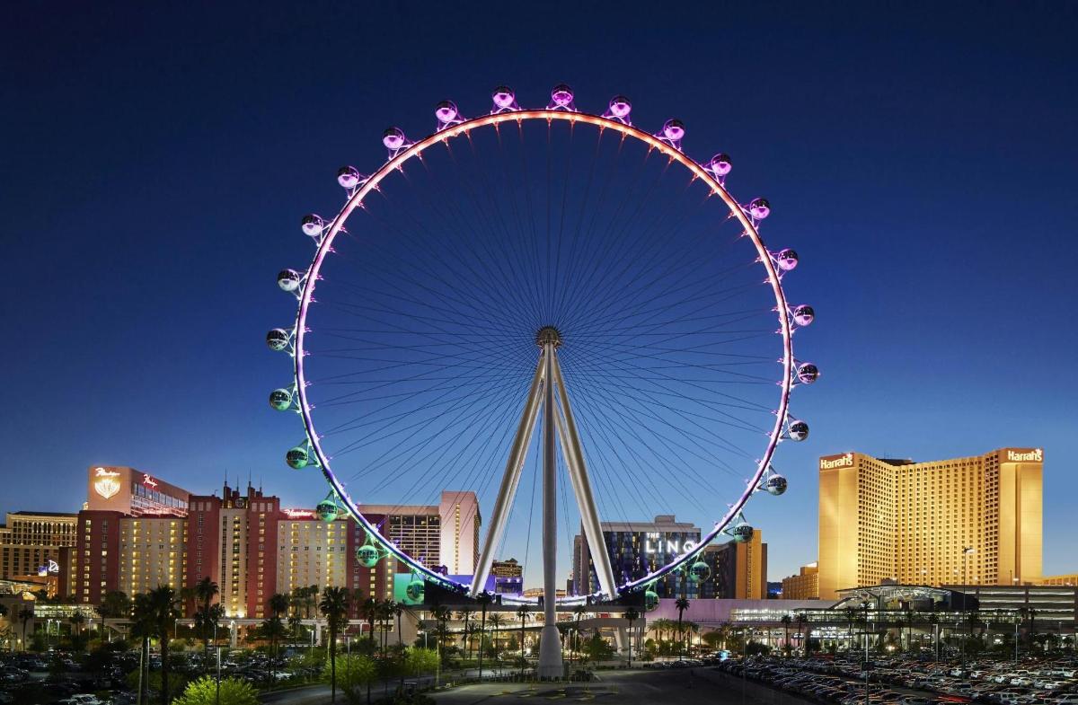 a large ferris wheel in a city at night
