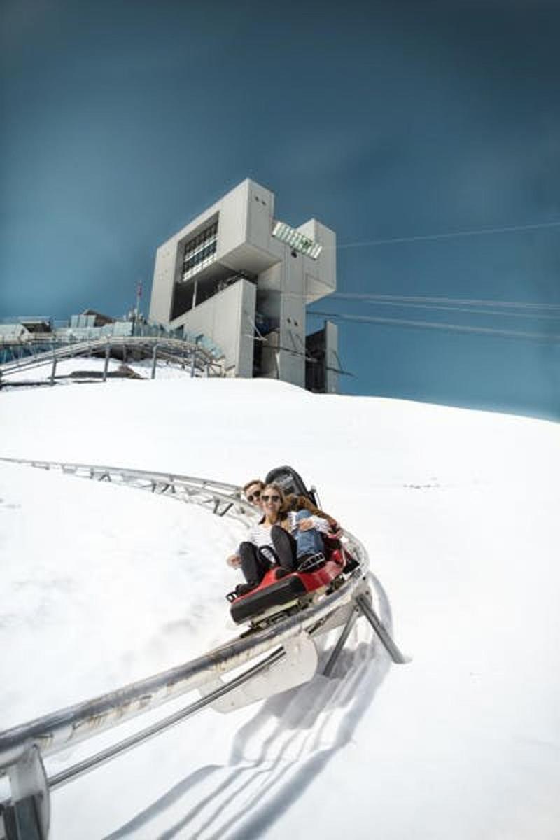 a woman riding on a ski lift in the snow