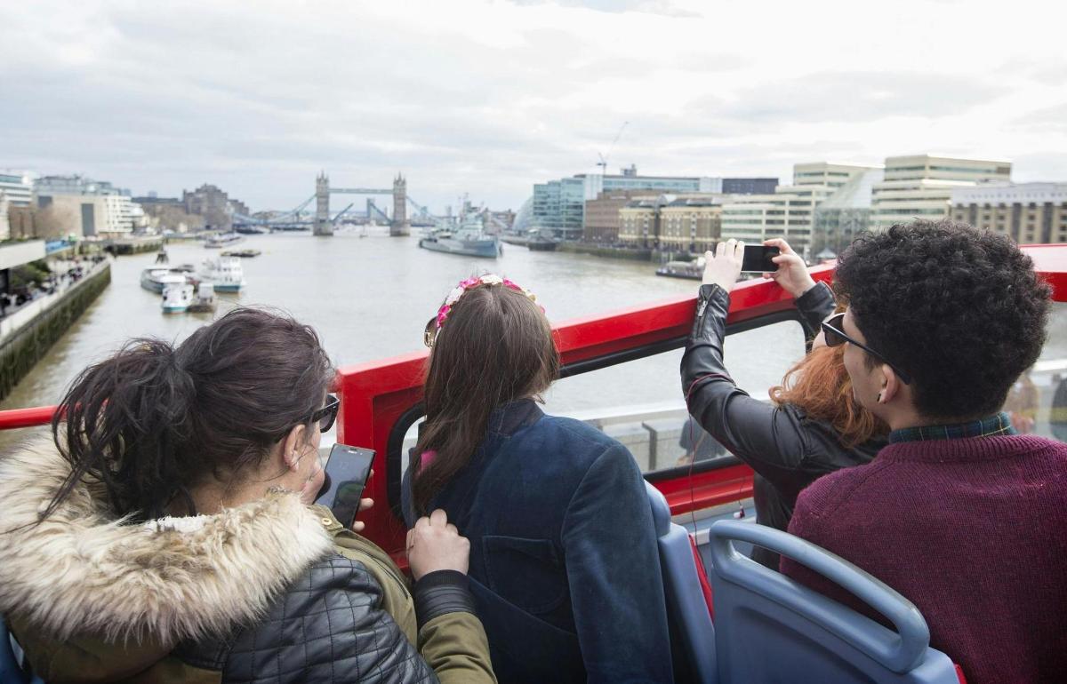 a group of people taking pictures of a river