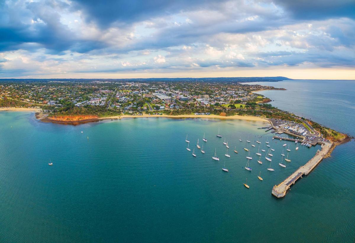 an aerial view of a harbor with boats in the water