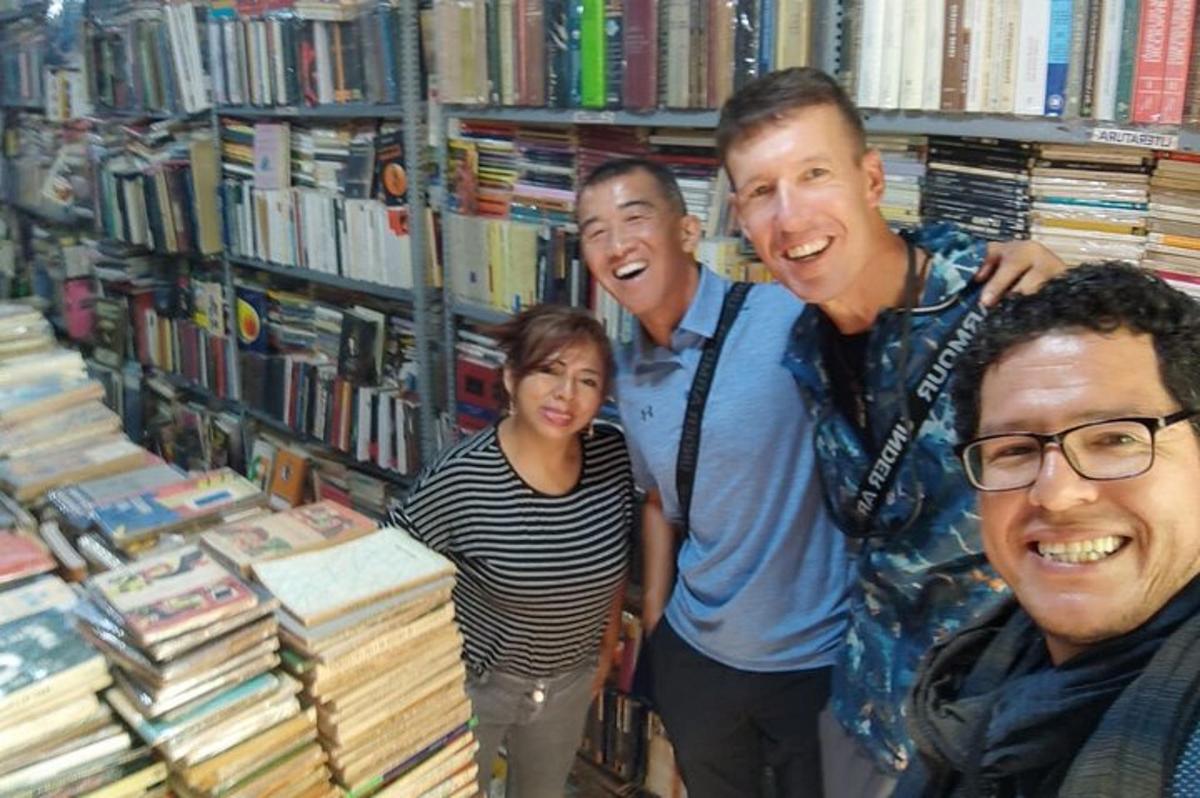 a group of people standing in a library with books