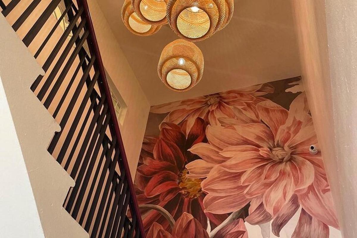 a staircase with a mural of flowers on the wall