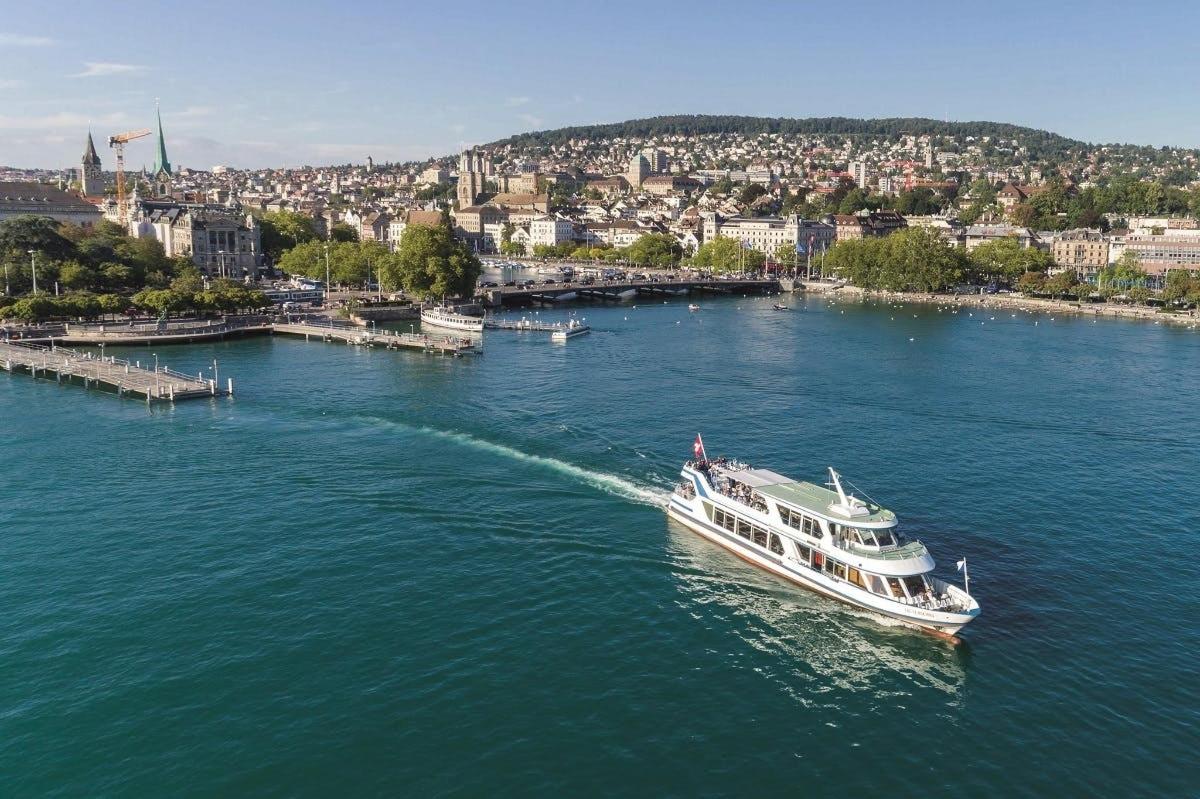 a boat on a river with a city in the background