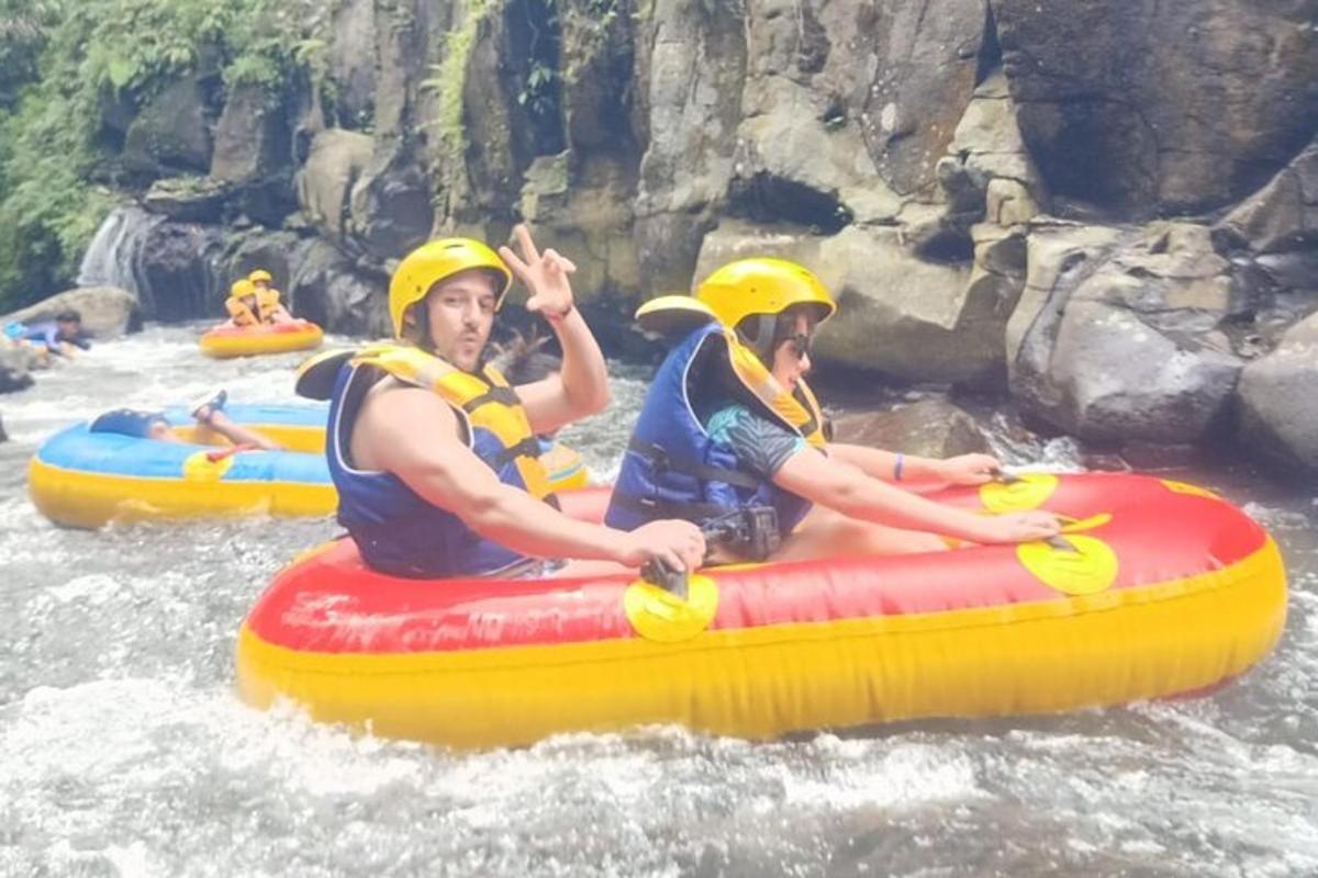 two people riding on a raft in the water