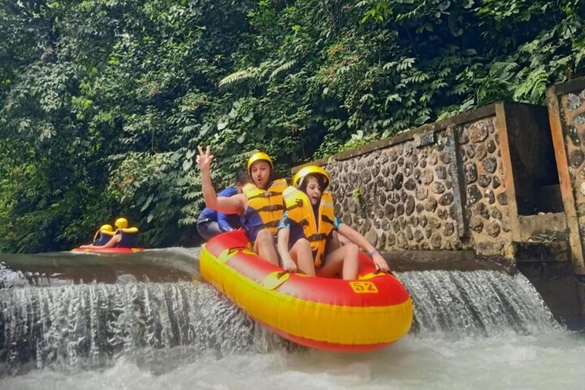 two people riding on a raft on a waterfall