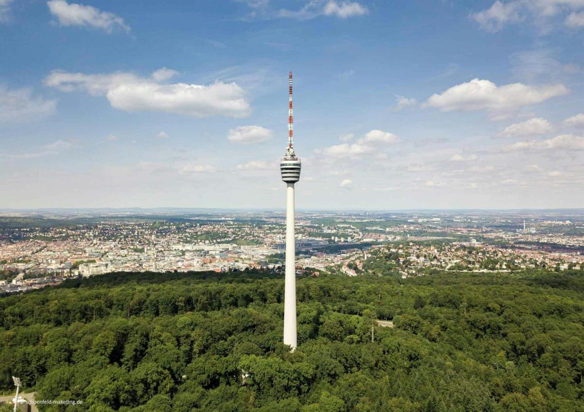 a tower on top of a hill with a city