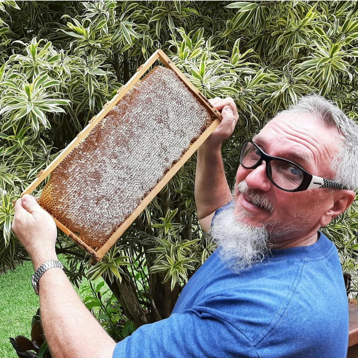 a man with glasses holding up
