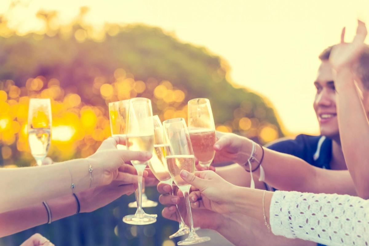 a group of people holding glasses of champagne