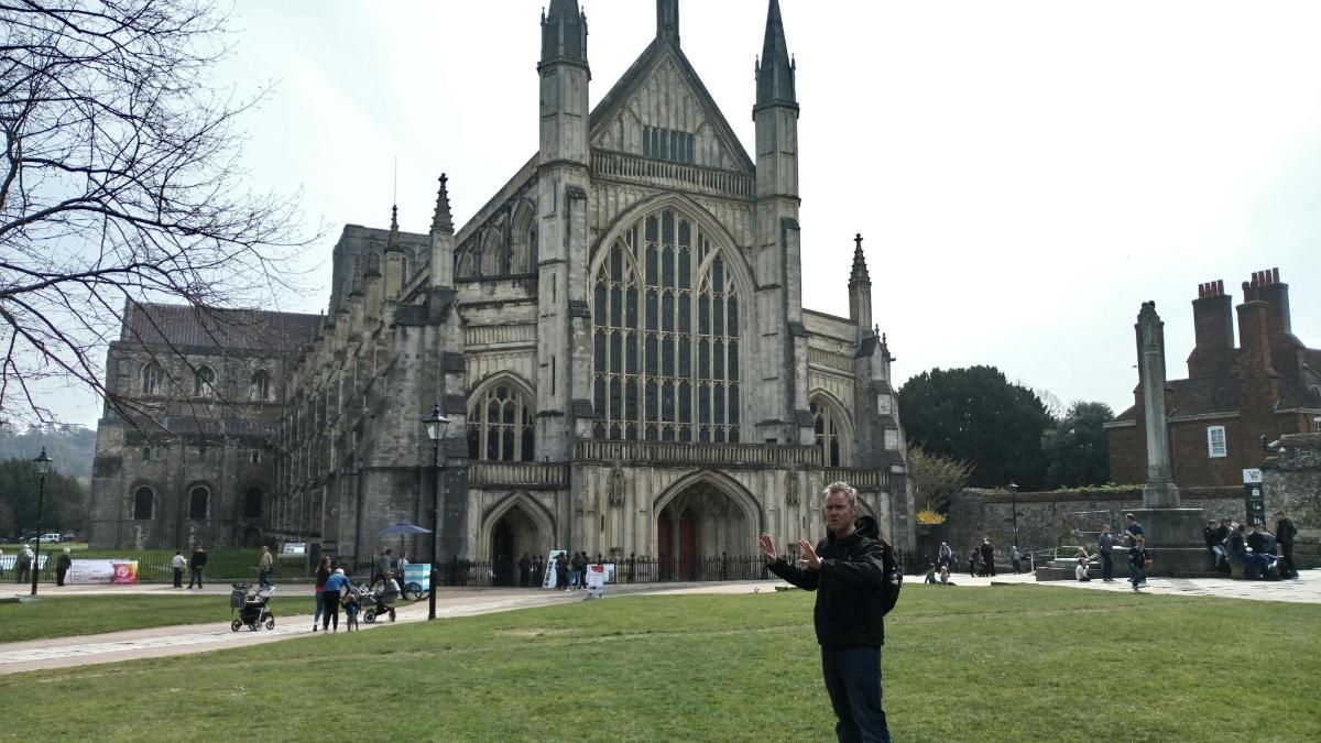 a man standing in front of a large building