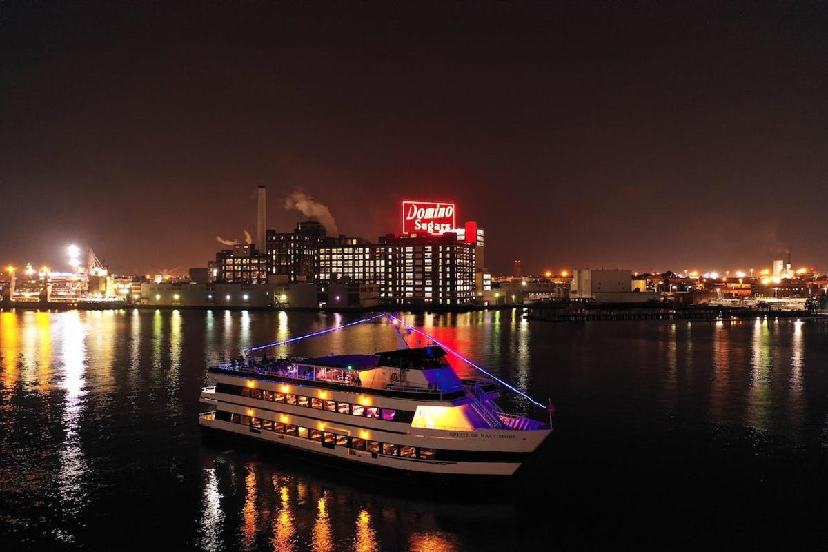 a boat in the water with a city at night