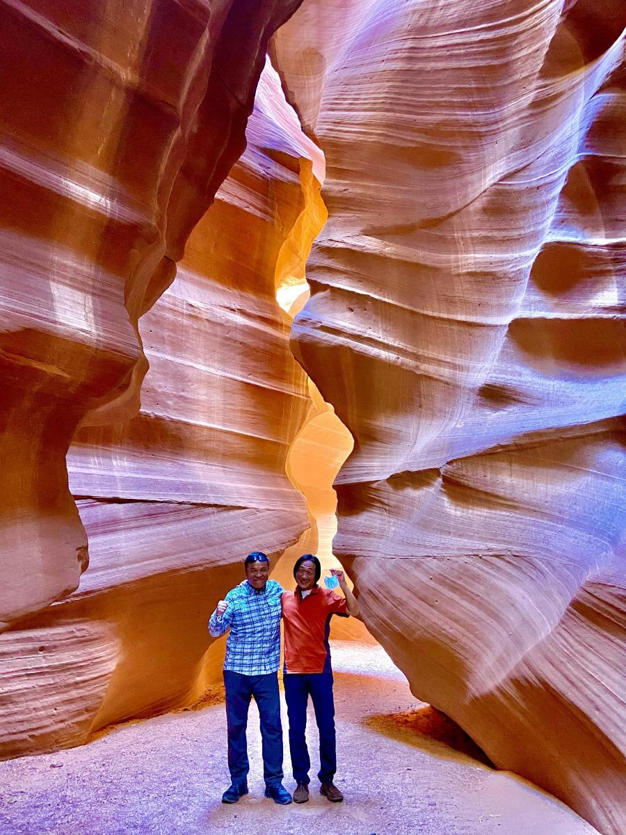 two men standing in a slot canyon