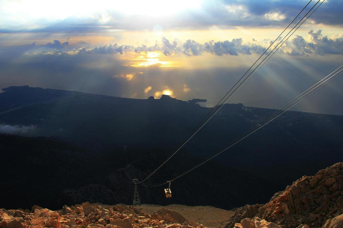 a view of the sun setting over a mountain