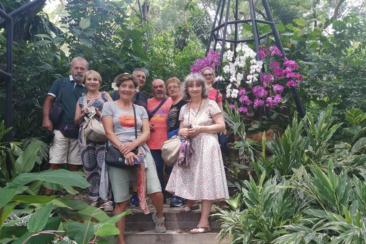 a group of people posing for a picture in a garden