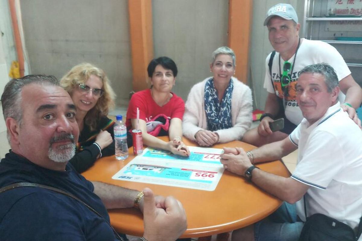 a group of people sitting around a table with a box