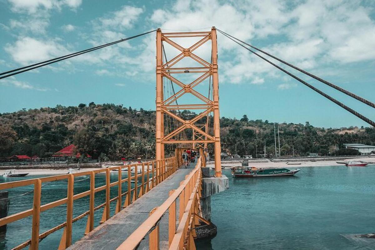 μια γέφυρα πάνω από το νερό με ανθρώπους να περπατούν πάνω της