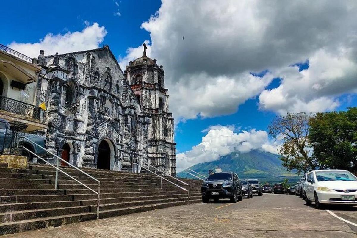 an old building with cars parked in front of it