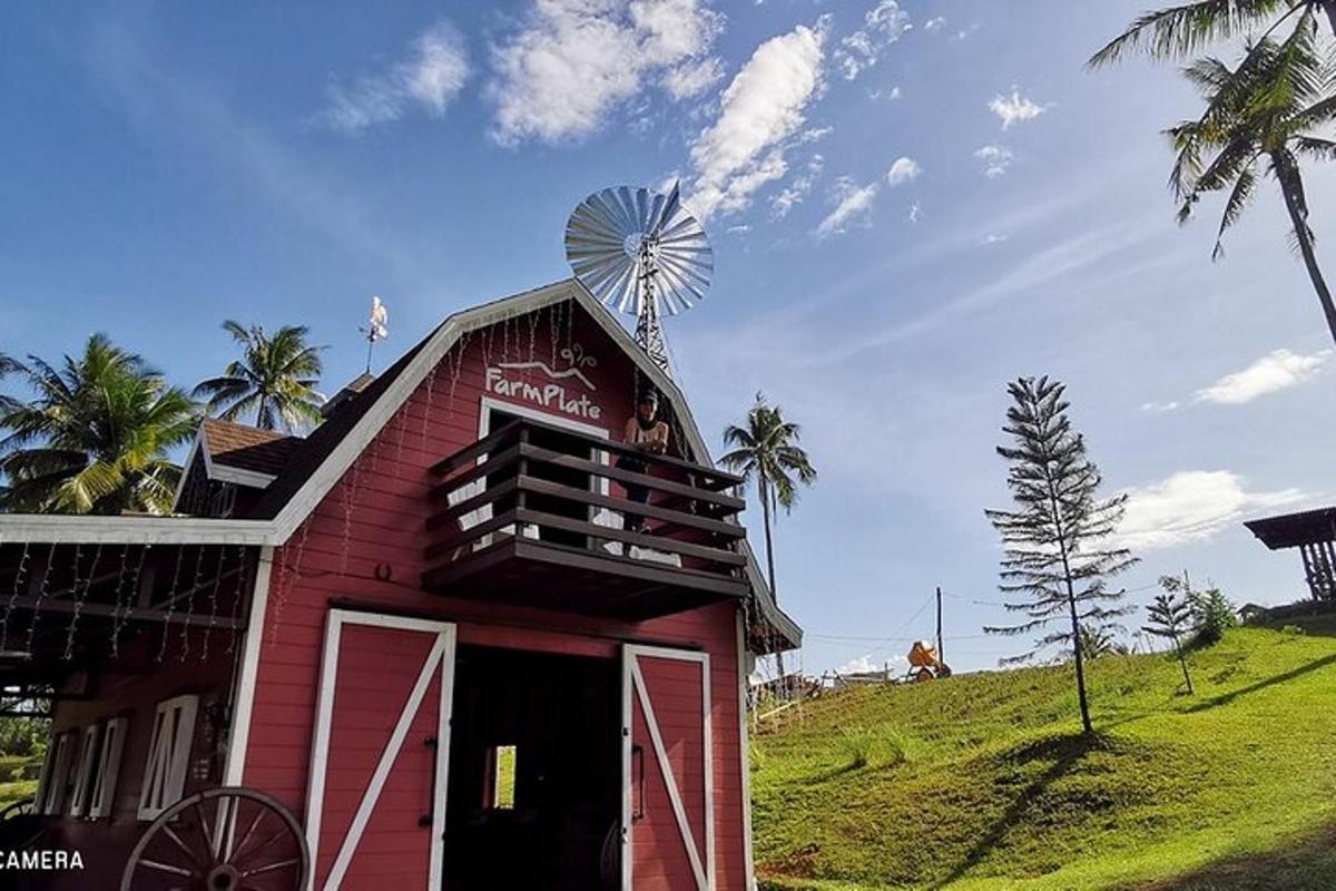 a red barn with a windmill on top of it