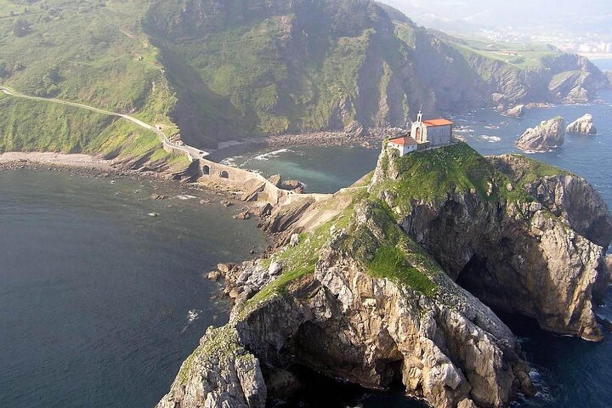 a house on top of a mountain in the ocean
