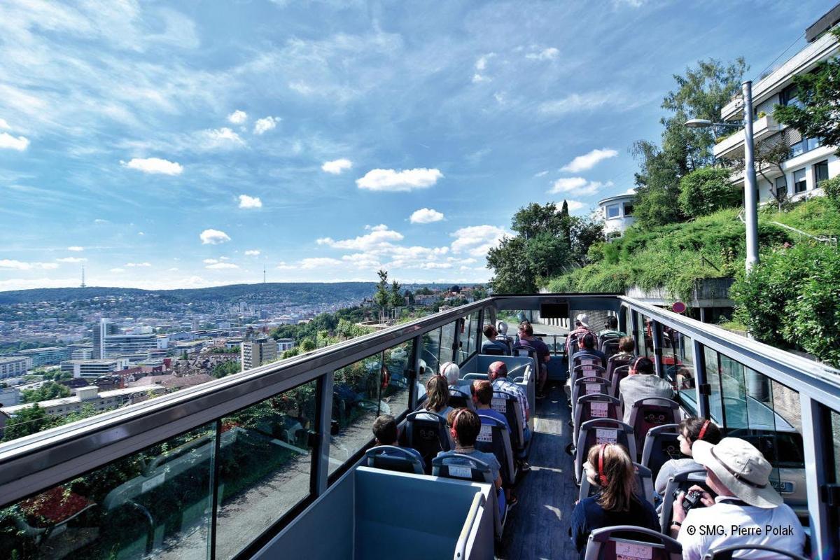 people riding on a tram up a hill