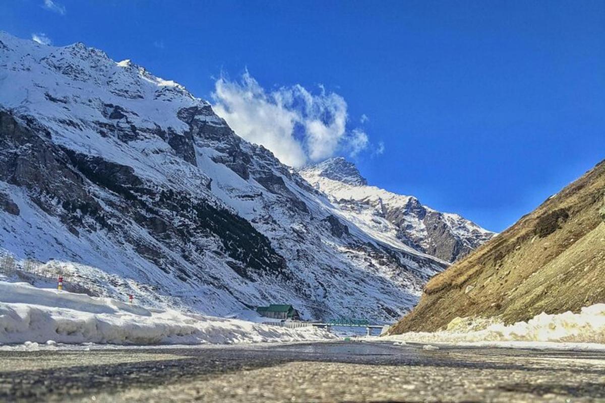 a snow covered mountain with a river in front of it