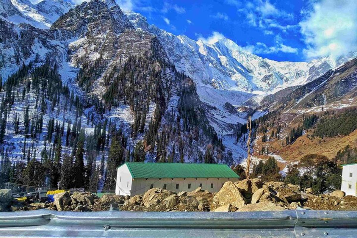 a building on the side of a mountain with snow