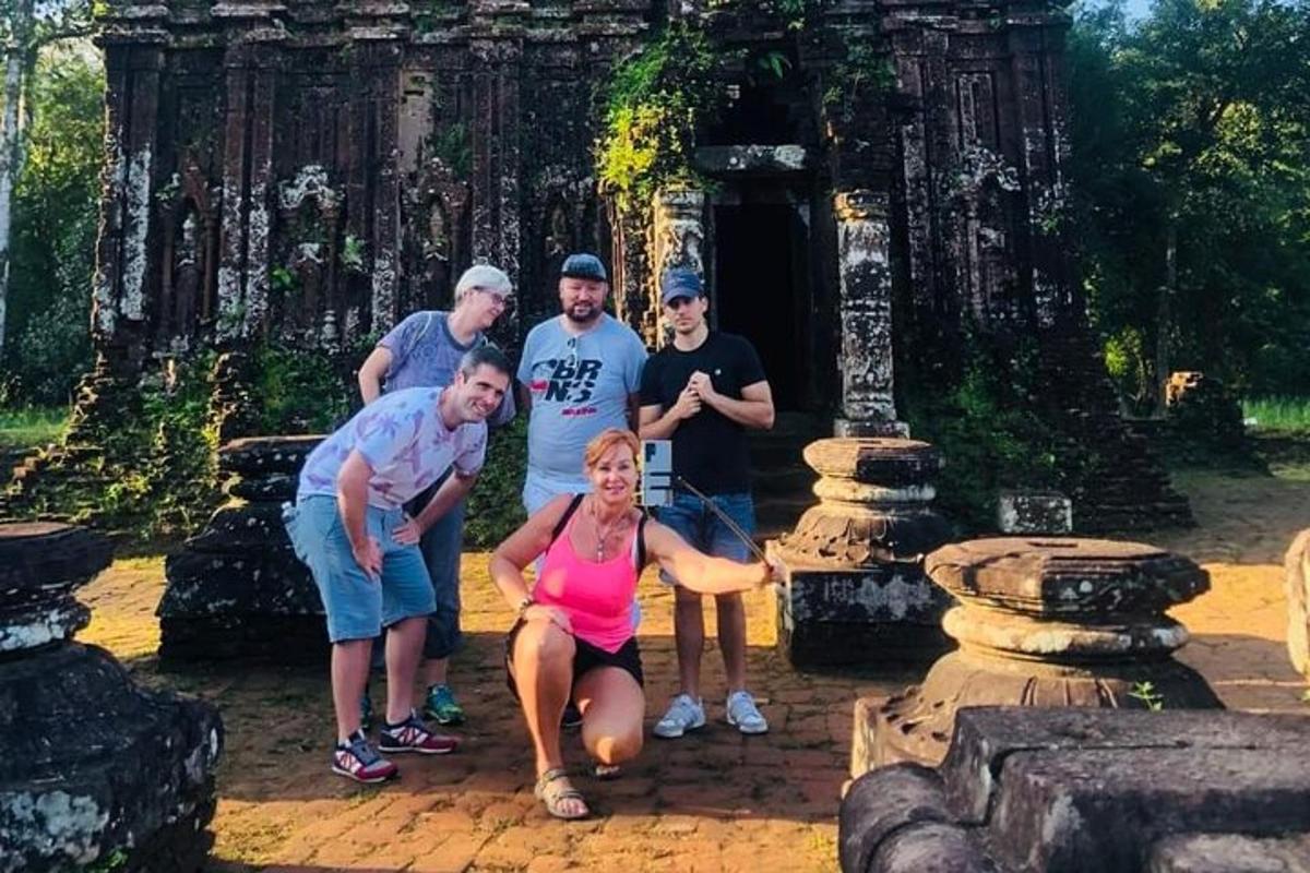 a group of people posing in front of a temple