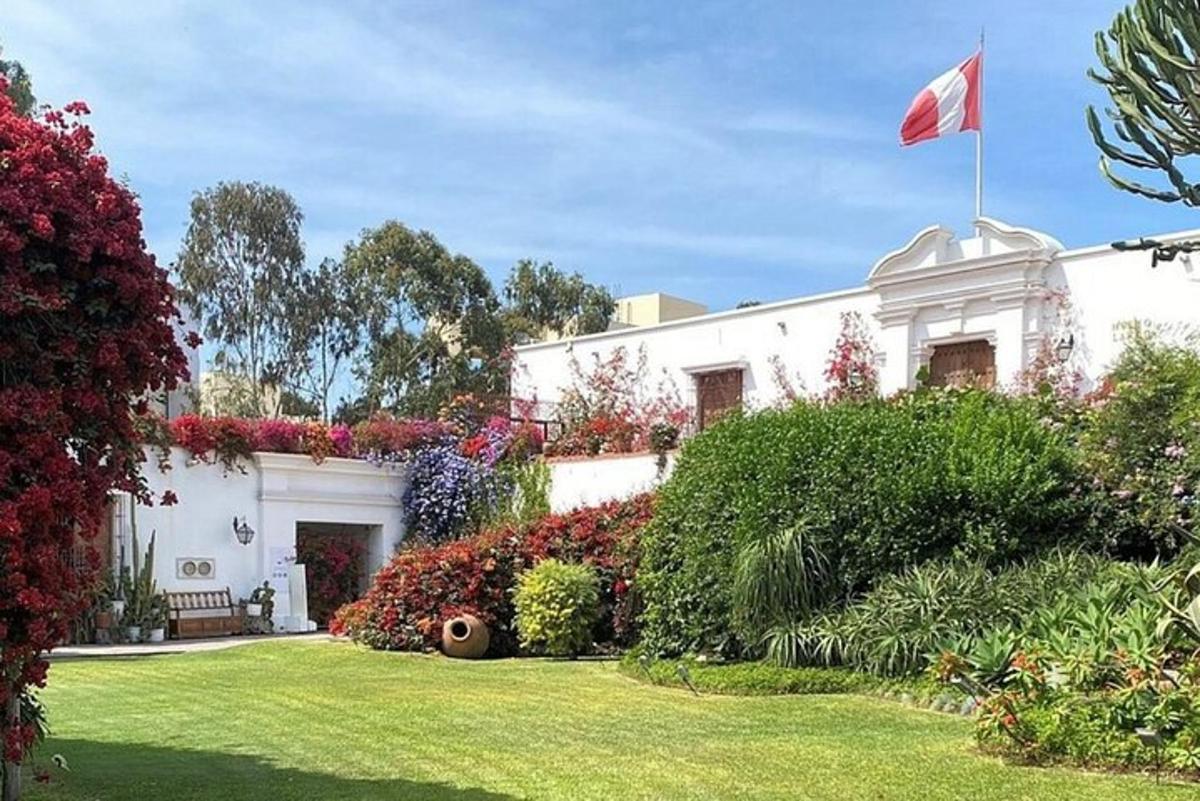 a white house with a flag in the yard